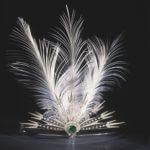 Aigrette : A headdress consisting of a white feather of egret or other decoration such as a spray of gems.