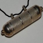 Amulet : An ornament or small piece of jewellery thought to give protection against evil, danger or disease.