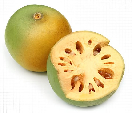 A bael fruit with a halved part, displaying its juicy flesh and bright colors
