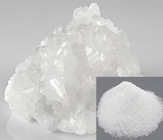 Borax White borax crystals beside a mound of its white powder.