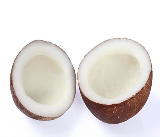 Copra Two halves of a dried coconut displayed on a white background.