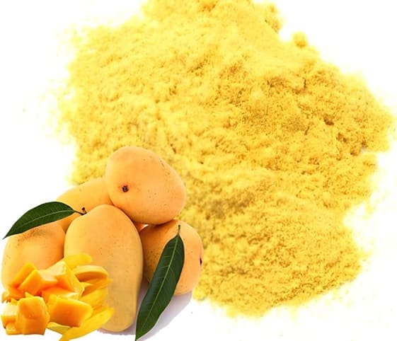 Dry Mango Powder Dry mango powder displayed alongside a fresh pile of ripe mangoes.