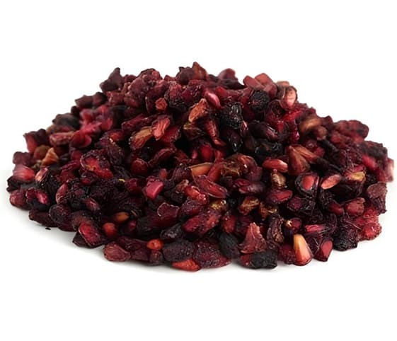 Dry Pomegranate Seeds A pile of dried pomegranate seeds arranged neatly on a clean white background.