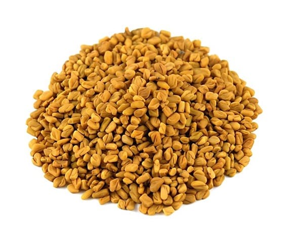 Fenugreek A close-up view of a pile of fenugreek seeds in white background.