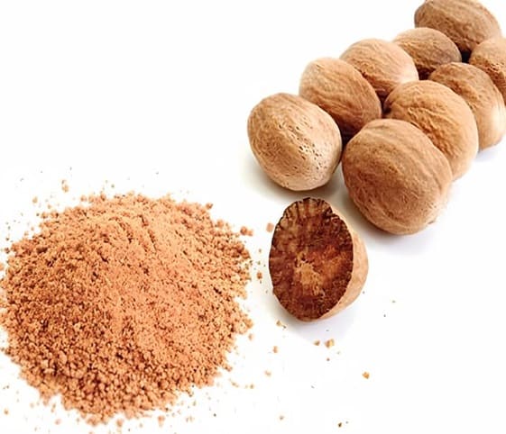 Nutmeg Nutmeg powder and whole nutmeg nuts arranged on a clean white background.