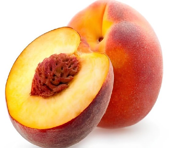 A fresh peach with a slice displayed against a plain white background