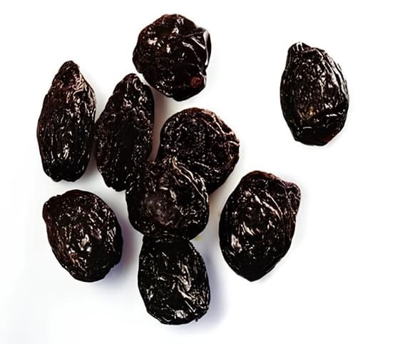 Prune A cluster of dried plums in white background.