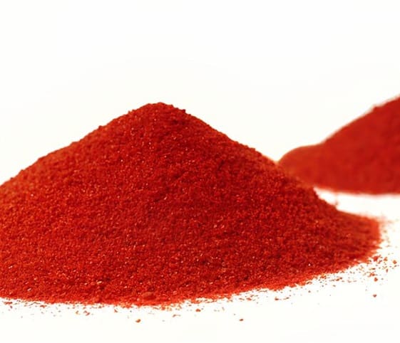 Red Chilli Powder A small mound of vibrant red chili powder sits against a clean white background.