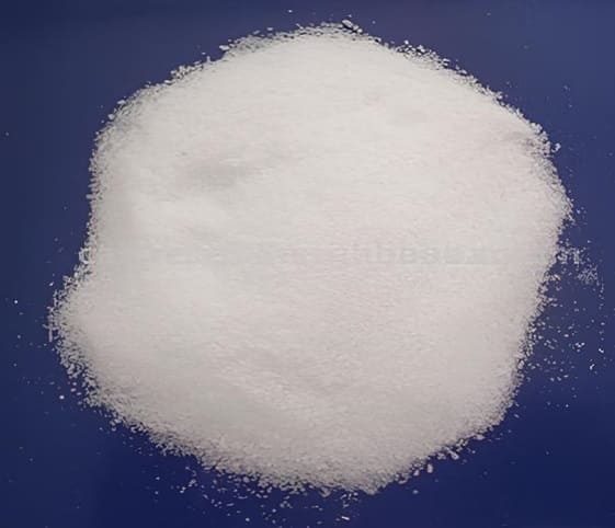 Saltpetre/Saltpeter A close-up of white saltpetre powder set against a vibrant blue background.