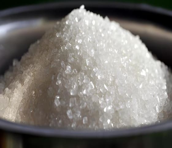 Thick Sugar A clear bowl filled with white sugar crystals.