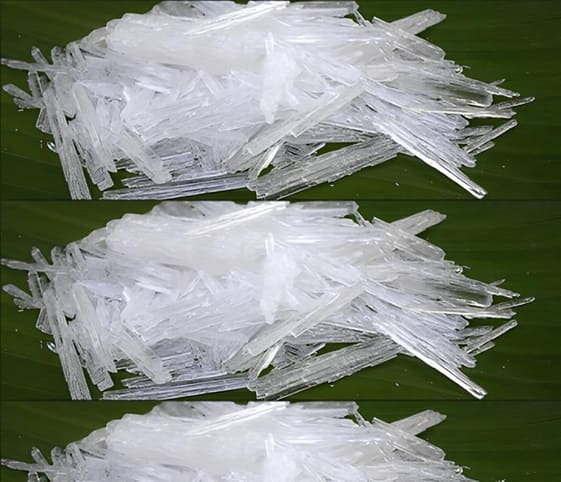 Thymol A pile of white crystals of Thymol rests on a vibrant green leaf.