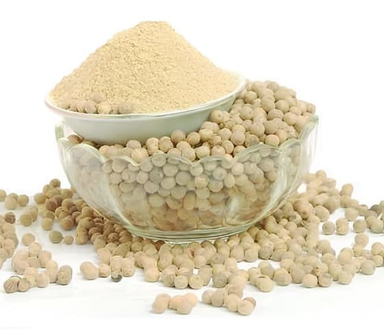 White Pepper Powder A bowl filled with white pepper powder next to another bowl brimming with whole white pepper.