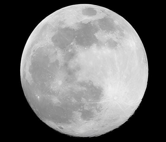 Moon A black and white image of a full moon, showcasing its luminous surface and intricate craters against a dark sky.